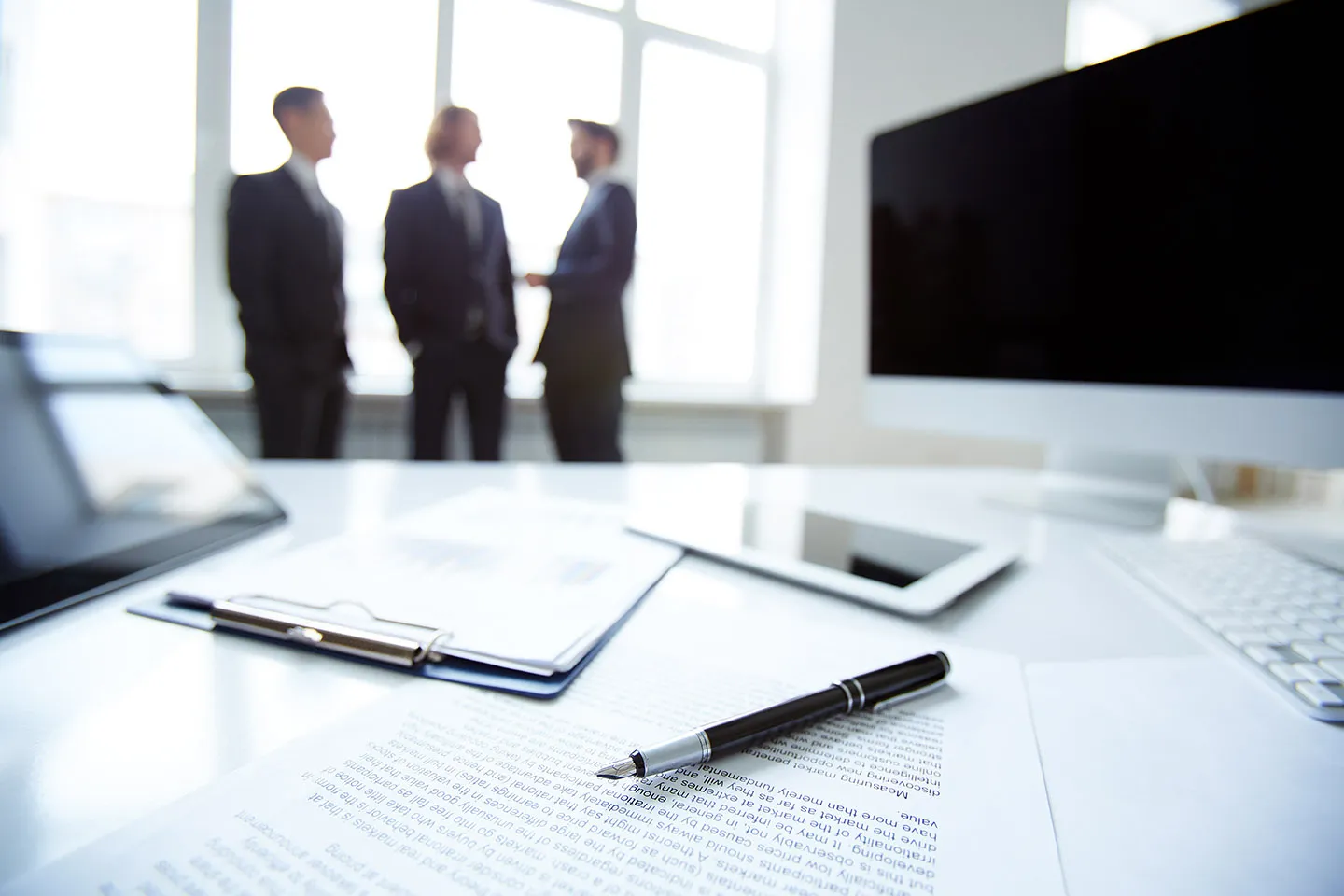 Legal team meeting around a boardroom table.